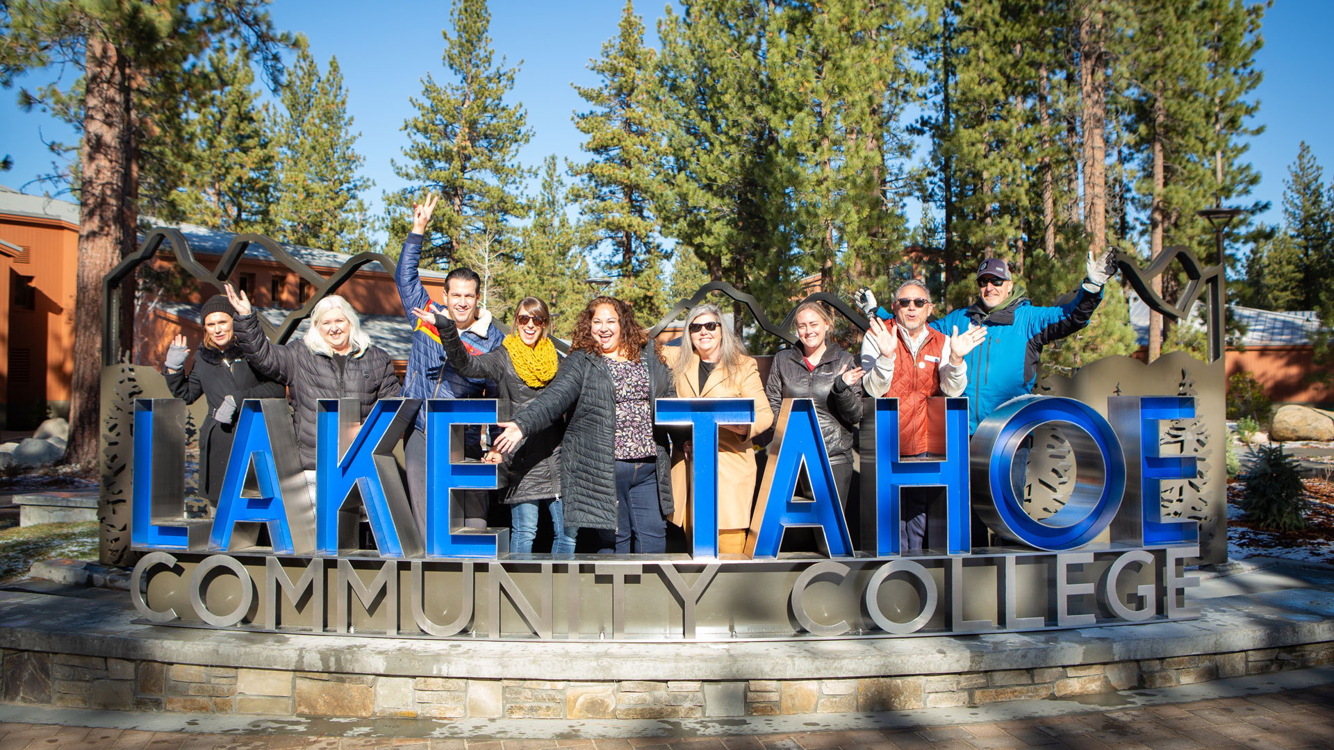 Senior Leadership at front entrance sign at Lake Tahoe Community College